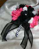   black accent flower. The stem is wrapped in black and white ribbon
